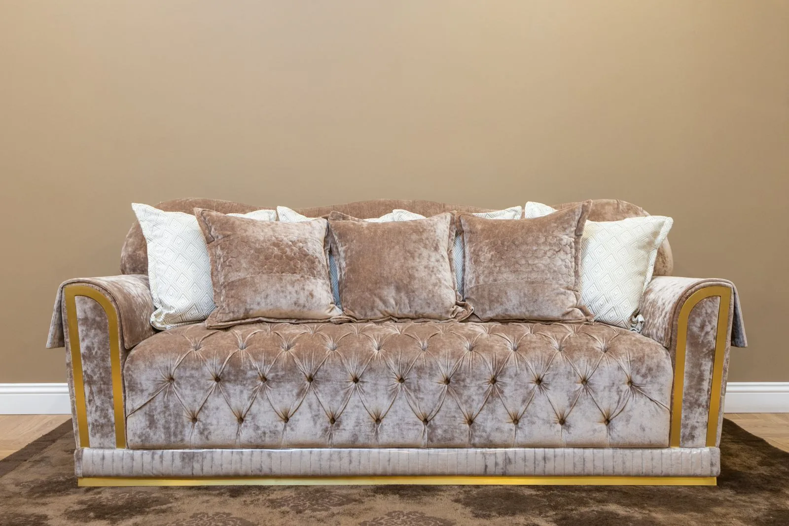 Beige upholstered sofa with plush cushions, the kind of seating that upholstery batting wraps
